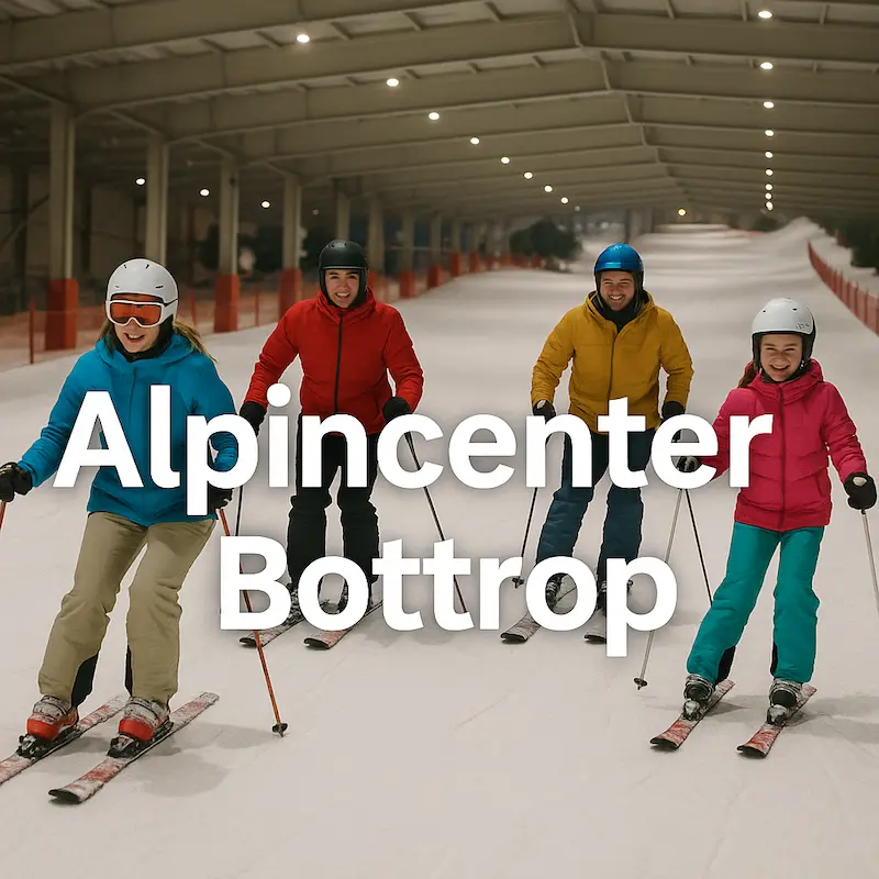 Vier fröhliche Skifahrer in bunter Kleidung fahren nebeneinander die Indoor-Piste im Alpincenter Bottrop hinab, unter dem Dach der längsten Skihalle der Welt.